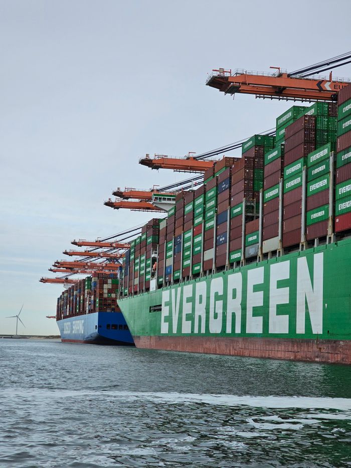 Large container ships docked at Maasvlakte, Rotterdam, showcasing global trade in action.